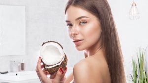 a woman holding a coconut