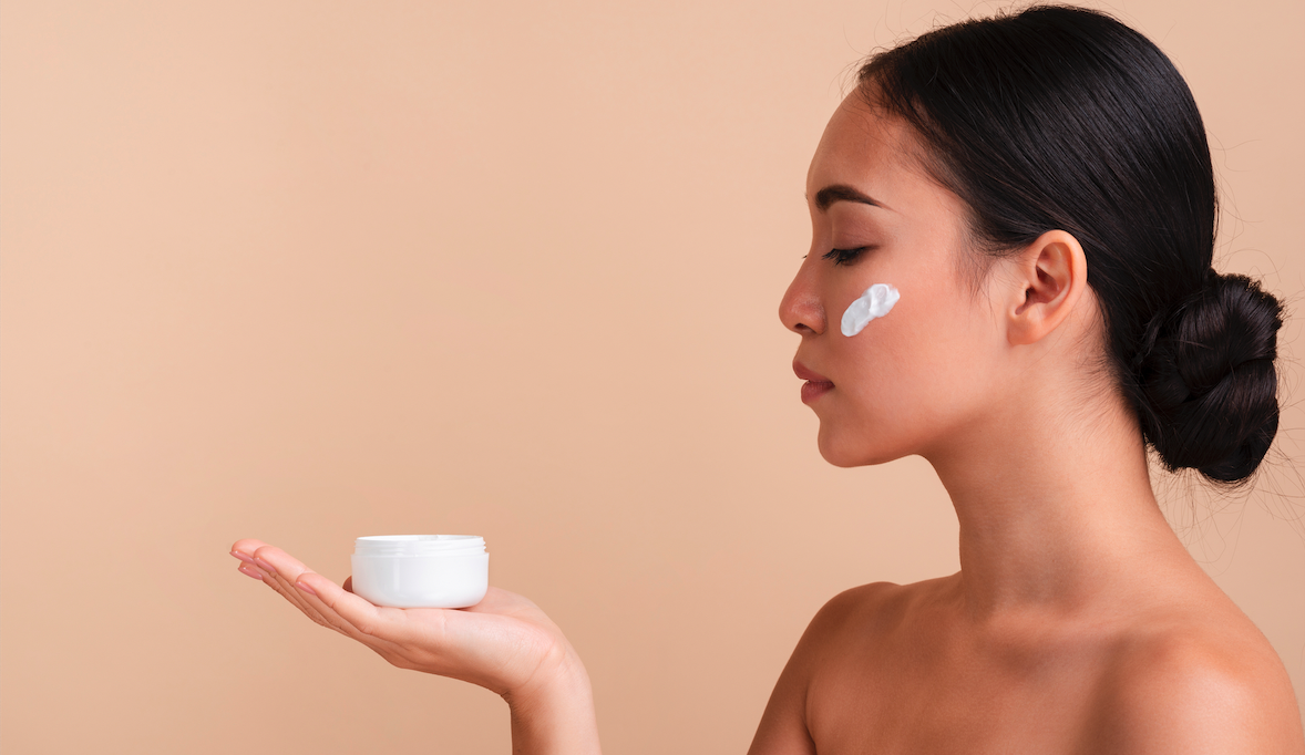 a woman holding a skin care product