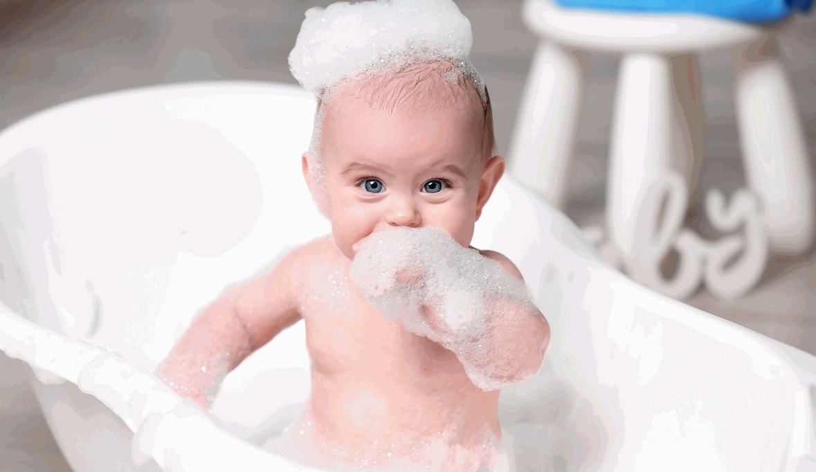 a baby with bubbles on a bath tub
