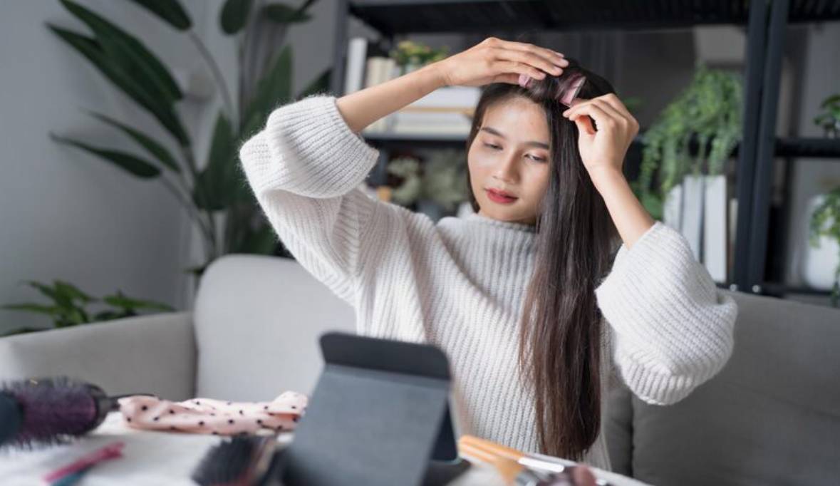 Beautiful asian lady getting ready applying haircare routine