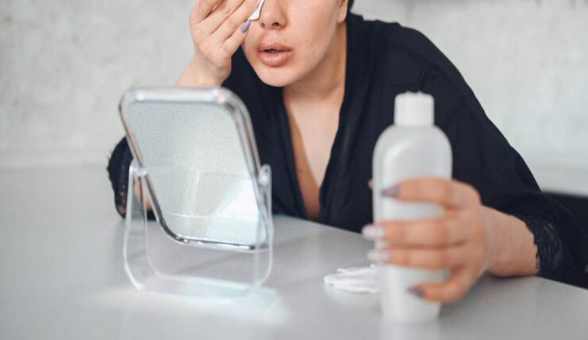 Woman cleaning face with cotton cosmetology spa problem skin care