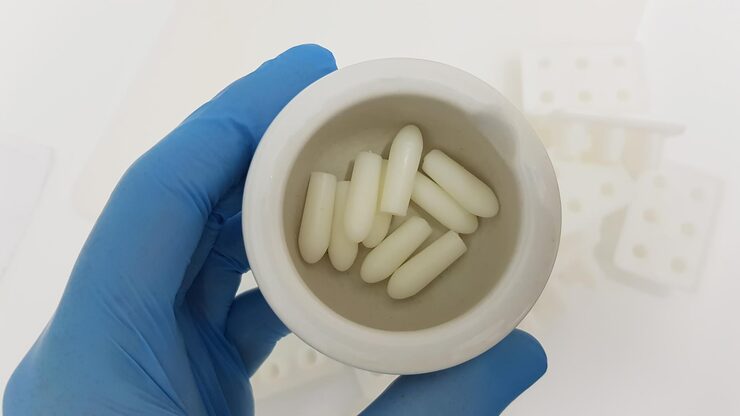 Close up shot scientists researchers hand holding suppositories pharmacy laboratory