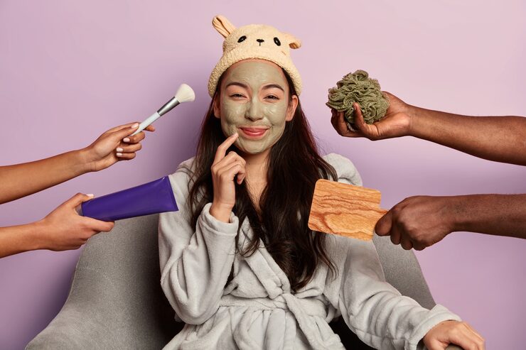 Young beautiful asian woman wears moisturizing face mask dressed